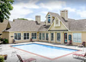 Thumbnail 12 of 12 - A house with a pool in front of it.