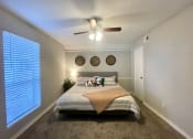 Thumbnail 20 of 30 - a bedroom with a large window and a ceiling fan  at 2151 Kirkwood, Houston, TX