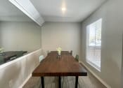Thumbnail 23 of 30 - a dining room with a long wooden table and a large window  at 2151 Kirkwood, Houston, 77077