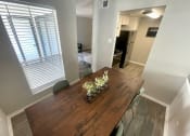 Thumbnail 18 of 30 - a dining room with a wooden table and green chairs  at 2151 Kirkwood, Houston, Texas