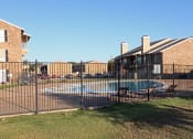 Thumbnail 3 of 3 - a swimming pool in front of a house behind a fence  at Wymberly Pointe, Grand Prairie, 75052
