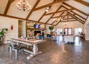 Thumbnail 1 of 15 - A large open living room with a dining table and chairs.