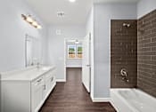 Thumbnail 6 of 7 - Master bathroom with double vanity and tiled shower at The Aurea Apartments, Houston, Texas