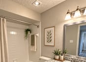 Thumbnail 14 of 14 - A bathroom with a toilet, sink, and mirror.