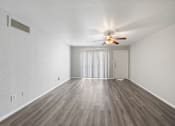 Thumbnail 11 of 15 - A room with a ceiling fan and a sliding door.