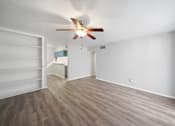Thumbnail 14 of 15 - A room with a ceiling fan and light fixture.