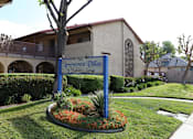 Thumbnail 1 of 37 - A sign for Arrowcrest Dillas stands in front of a building.
