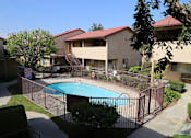 Thumbnail 25 of 37 - A pool surrounded by a fence in a residential area.