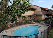 Thumbnail 33 of 37 - A tree is in front of a building with a pool.