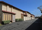 Thumbnail 13 of 37 - A row of houses with a clear blue sky above them.