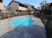 Thumbnail 10 of 37 - A small pool in a courtyard surrounded by a fence.