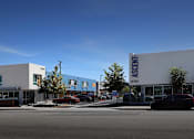 Thumbnail 5 of 77 - A car is parked in front of a building with a sign that reads "Ascent.".