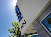 Thumbnail 3 of 77 - A sign with the word "JEBS" in blue letters above the number "8180" is mounted on a white wall.