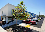 Thumbnail 4 of 77 - A modern building with a red car parked in front.