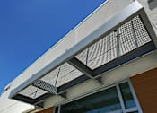 Thumbnail 13 of 77 - A building has a large air vent on the side.