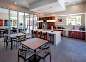 Thumbnail 61 of 77 - A modern kitchen with a dining table and chairs.