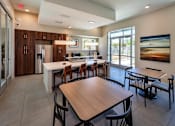 Thumbnail 52 of 77 - A modern kitchen with a dining table and chairs.