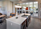 Thumbnail 58 of 77 - A kitchen with a white counter top and stainless steel appliances.