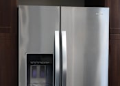 Thumbnail 59 of 77 - A stainless steel refrigerator with its door open.