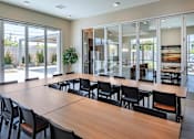 Thumbnail 54 of 77 - A conference room with a long table and chairs.