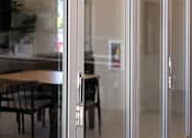 Thumbnail 39 of 77 - A glass door with a handle is open.