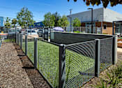 Thumbnail 25 of 77 - A long metal fence runs along a gravel path.