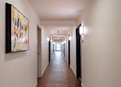 Thumbnail 77 of 77 - A long hallway with a painting on the wall.