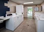 Thumbnail 67 of 77 - A clean, modern kitchen with white appliances and a tiled floor.