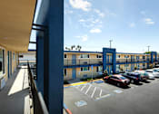 Thumbnail 19 of 37 - A parking lot with a blue building in the background.