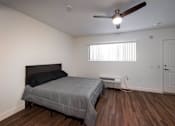 Thumbnail 17 of 37 - A bedroom with a bed, a ceiling fan, and a window with blinds.