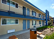 Thumbnail 9 of 37 - A building with blue trim and a balcony.