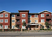 Thumbnail 2 of 2 - Apartment building with red brick and white trim.