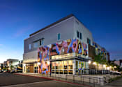 Thumbnail 113 of 116 - A modern building with a colorful mural on the side.