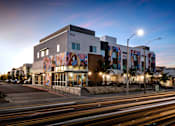 Thumbnail 108 of 116 - A modern building with a colorful mural on the side.