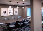 Thumbnail 111 of 116 - A conference room with a long table and chairs.