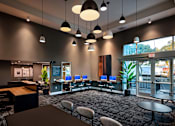 Thumbnail 101 of 116 - A modern office space with a reception desk, chairs, and computers.