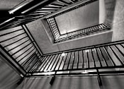 Thumbnail 116 of 116 - A black and white image of a staircase with metal railings.