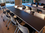 Thumbnail 110 of 116 - A conference room with a long table and chairs.