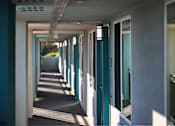 Thumbnail 89 of 116 - A long corridor with doors on both sides.