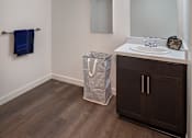 Thumbnail 81 of 116 - A bathroom with a wooden floor and a white sink.