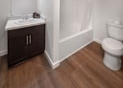 Thumbnail 96 of 116 - A white bathroom with a toilet, sink, and a shower curtain.