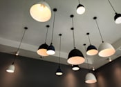 Thumbnail 95 of 116 - A series of hanging lights are suspended from the ceiling.