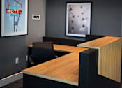 Thumbnail 90 of 116 - A modern office with a wooden desk and a framed picture of a motel sign.