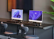 Thumbnail 94 of 116 - Two computers are on a desk with chairs.
