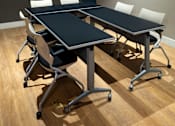 Thumbnail 69 of 116 - A conference room with a table and chairs.