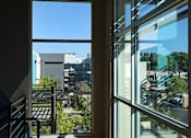 Thumbnail 63 of 116 - A room with a view of the city through large windows.