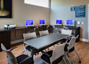 Thumbnail 68 of 116 - A room with a long table and chairs with computers on the table.