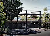 Thumbnail 38 of 116 - A black metal gate with a decorative arch above it.