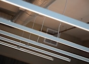 Thumbnail 26 of 116 - A series of white lines are suspended from the ceiling.