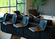 Thumbnail 25 of 116 - A row of black chairs are lined up in front of a window.